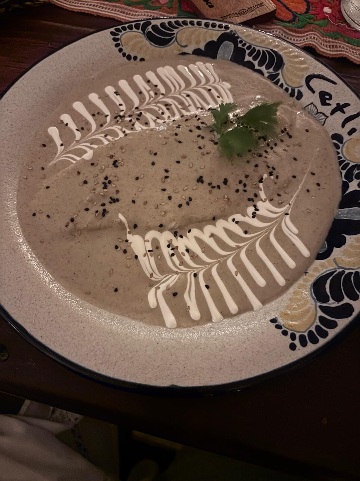 Traditional Mexican mole dish with decorative sauce at Cetli