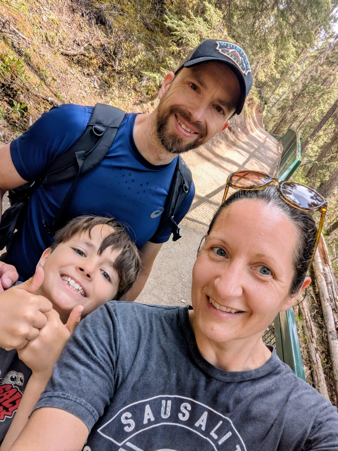 The Allans family smiling on a woodland trail