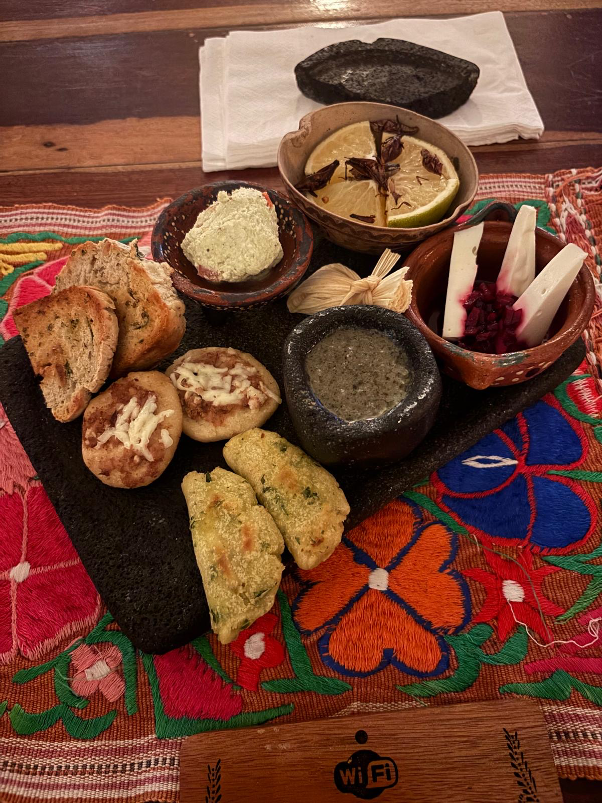 Appetizer platter with sopes, guacamole, cheese and chapulines at Cetli