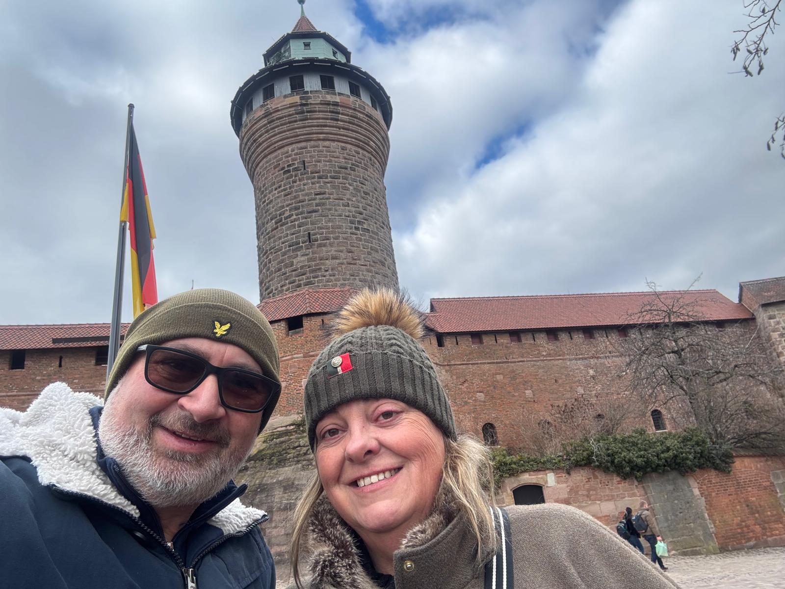 Alison and Tony taking a selfie in front of Nuremberg Castle's Sinwell Tower